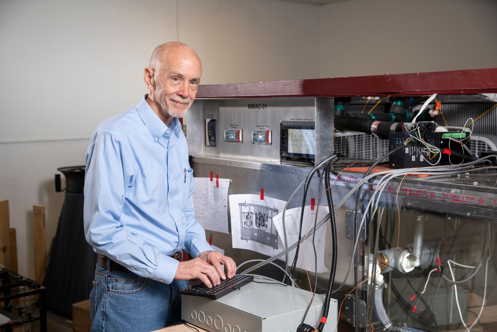 Culp stands in front of his homemade ventilation and air conditioning system.