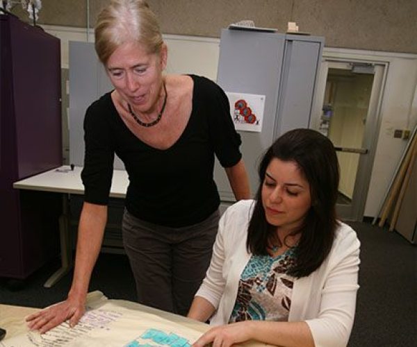 Two people looking at blueprints