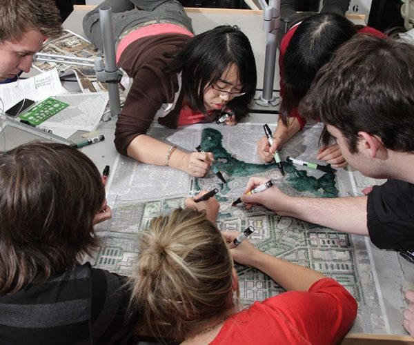 Six students color in landscape architecture design plans