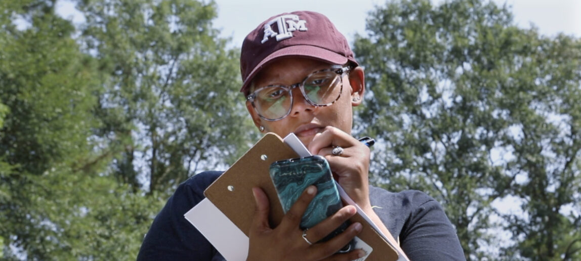 Jennifer Blanks, a Ph.D student at Texas A&M, takes notes outdoors