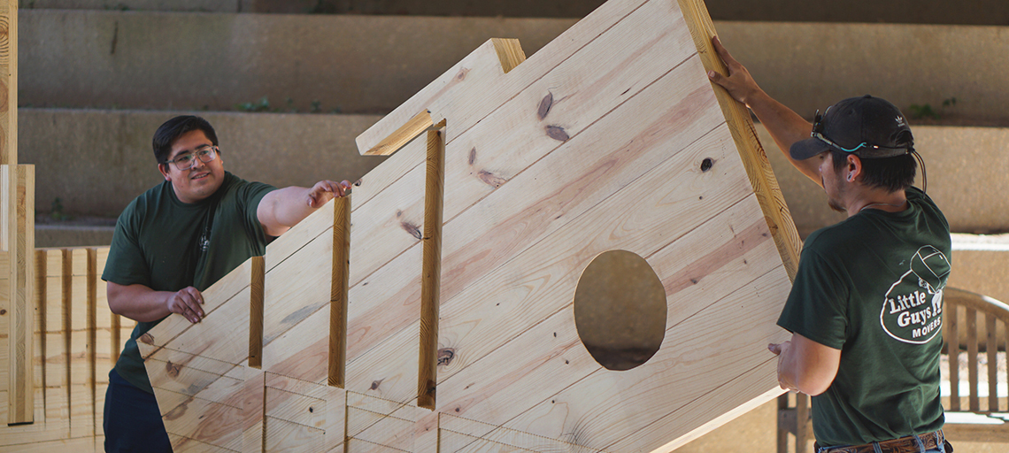 Men move a wooden structure