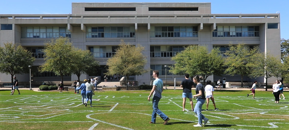 Students walk through a labyrinth patterns drawn on the Langford quad.