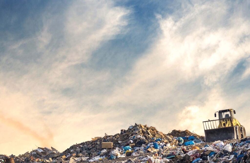 Dump full of debris in front of beautiful skyline