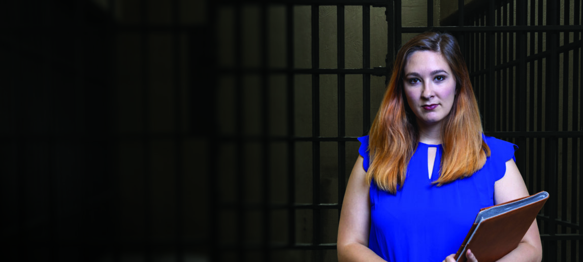 Carlee Purdum standing in front of prison cell