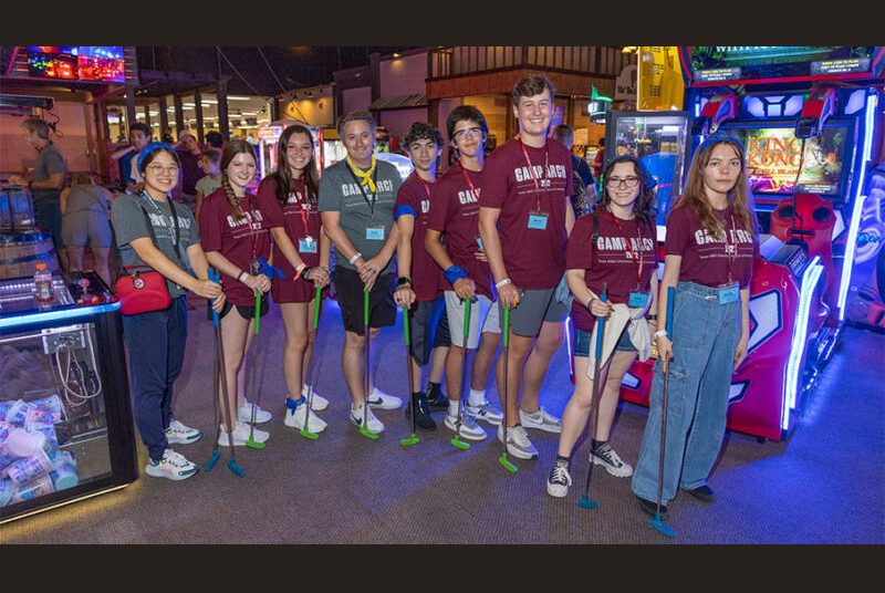 Camp ARCH counselors pose with mini golf clubs at Grand Station Entertainment