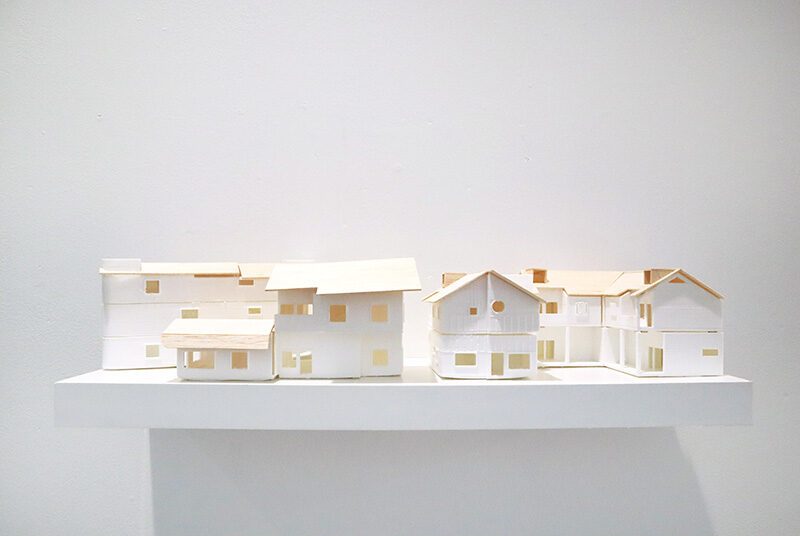A close up photograph of four different 3D printed duplex models made out of PLA and balsa wood.