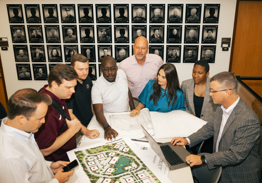 Action shot for DIAC members looking over land plans