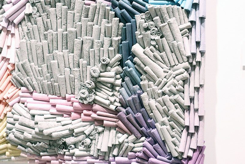 A close up view of rolled papers Jenn Hassin used to create her artwork Vibrant Paths.