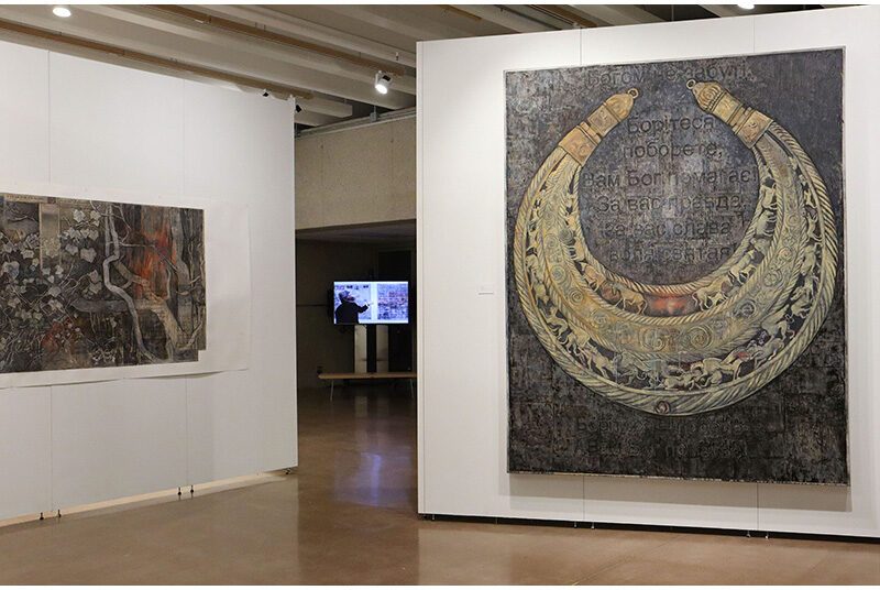 A view of two artworks. The artwork on the left features the last panel of Pandemic Lamentations Part 3. The artwork on the right features a dark background with Cyrillic text with a horse shoe shaped design with animals and patterns inside.