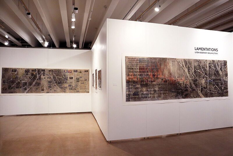 A view of the Lamentations exhibition featuring two dark toned artworks that cover most of the gallery walls