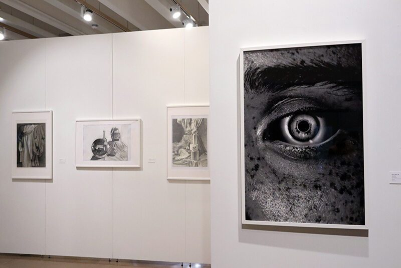 A view of 3 still life drawings and 1 photograph featuring an upclose image of an eye.