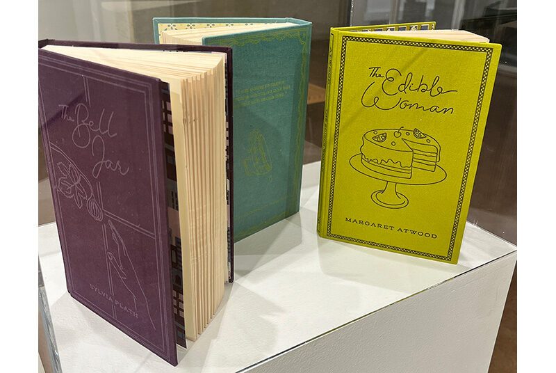 A display of 3 redesigned book covers of classic literature.