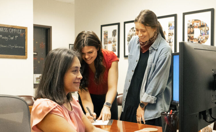 A staff member helps a student with a financial issue in the business office