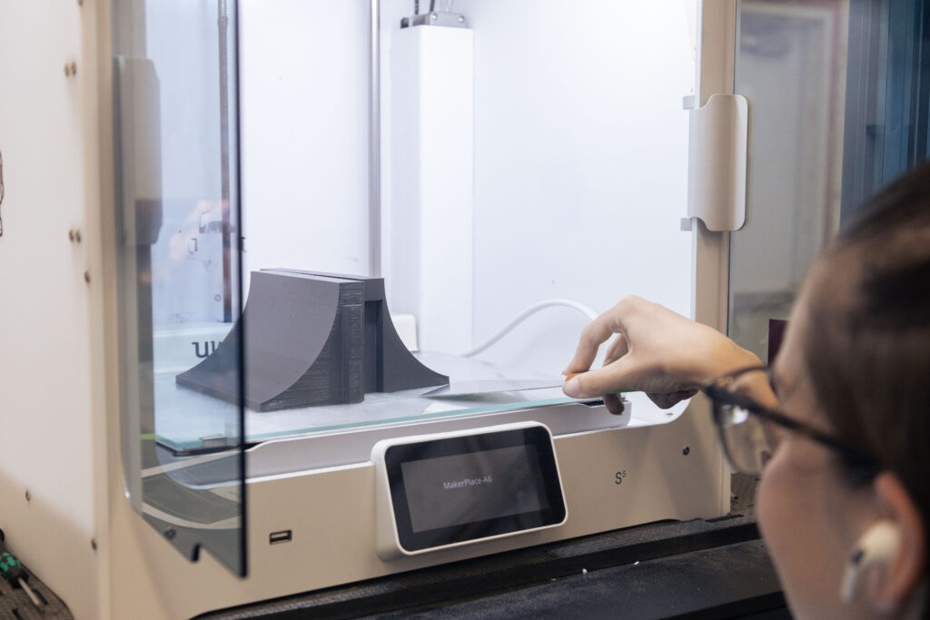 A student working with 3D material in a workshop.