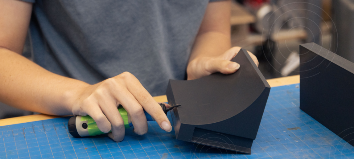 A student working with 3D material in a workshop.