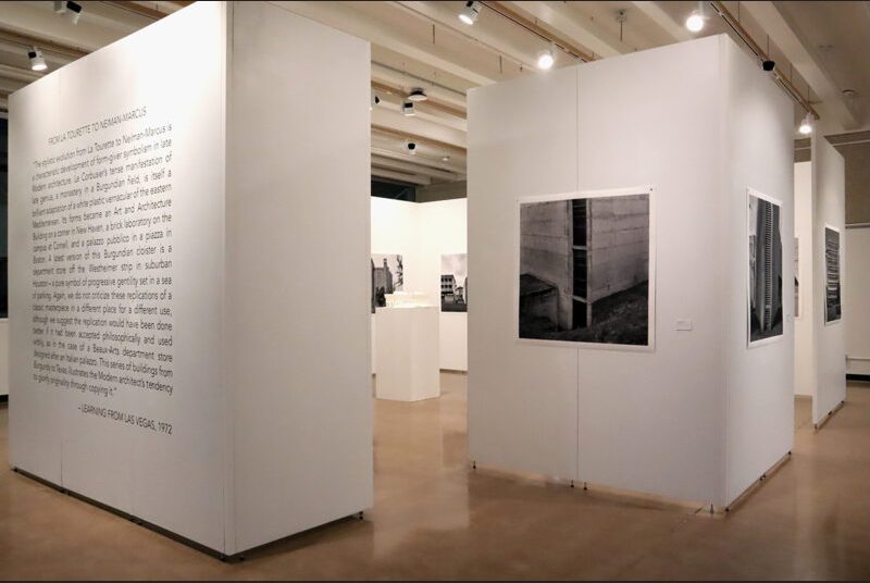 Print of Leonid Formansky’s “La Tourette Convent #2” with an excerpt from the 1972 book “Learning from Las Vegas” in black vinyl on a white wall to the left of it.