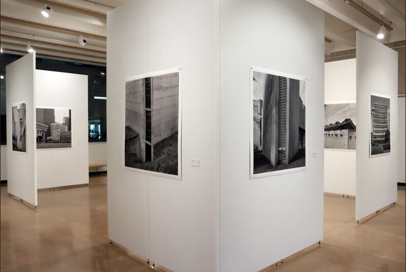 Print of Leonid Formansky’s “La Tourette Convent #2” on a white wall, with a print of Leonid Formansky’s “Central Fire Station” opposite it.