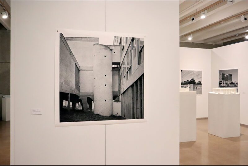 Black and white photograph by Leonid Formansky of “La Tourette Convent #8” on a white wall. There are two pedestals in the background with photographs on the walls.