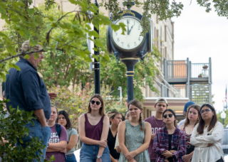 A guest speaker was talking with students in downtown Bryan.