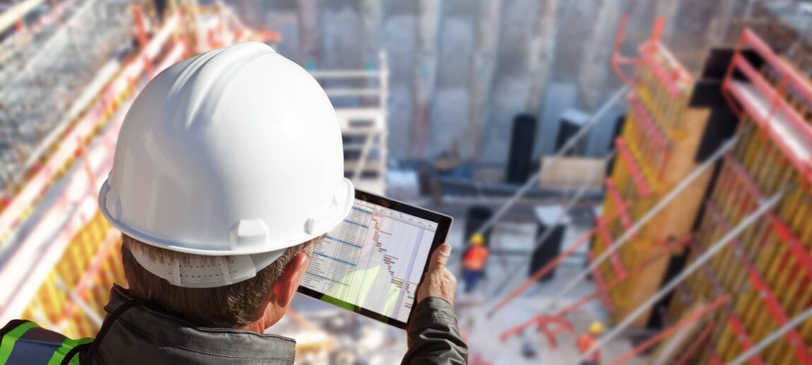 Engineer architect construction worker on construction site with tablet computer