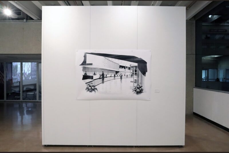 A large black and white painting of a bank is on a white wall.