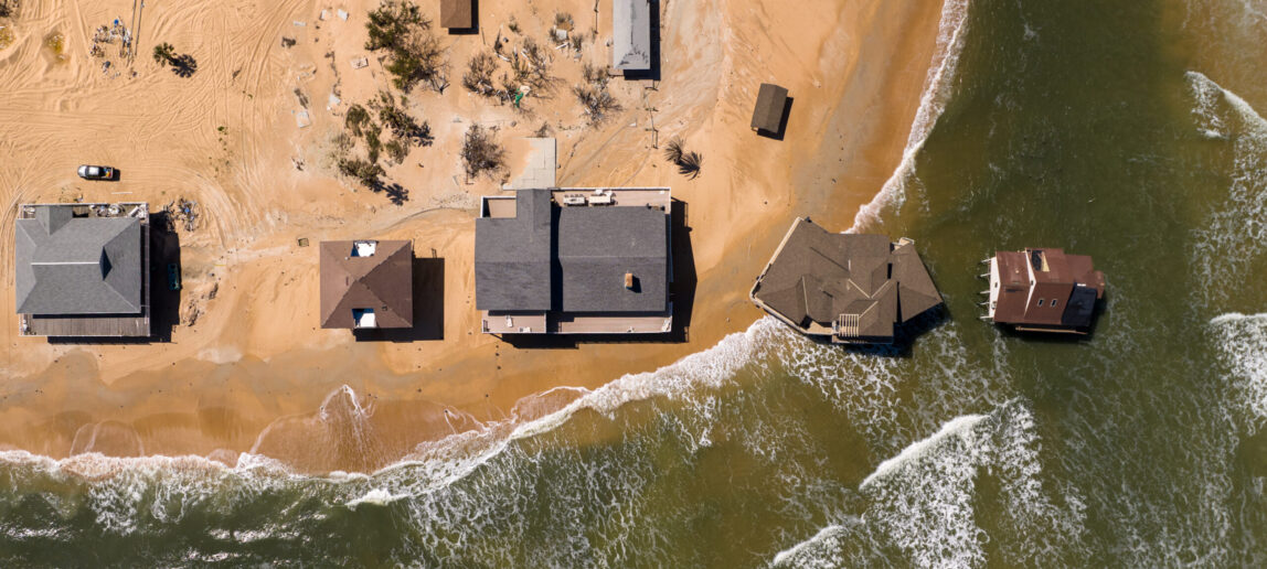 Aerial view of residential housing near a body of large water.