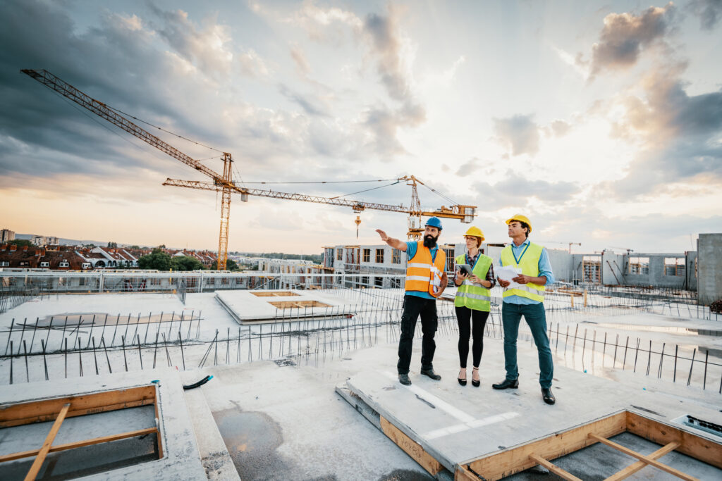 Successful engineers having meeting on construction site