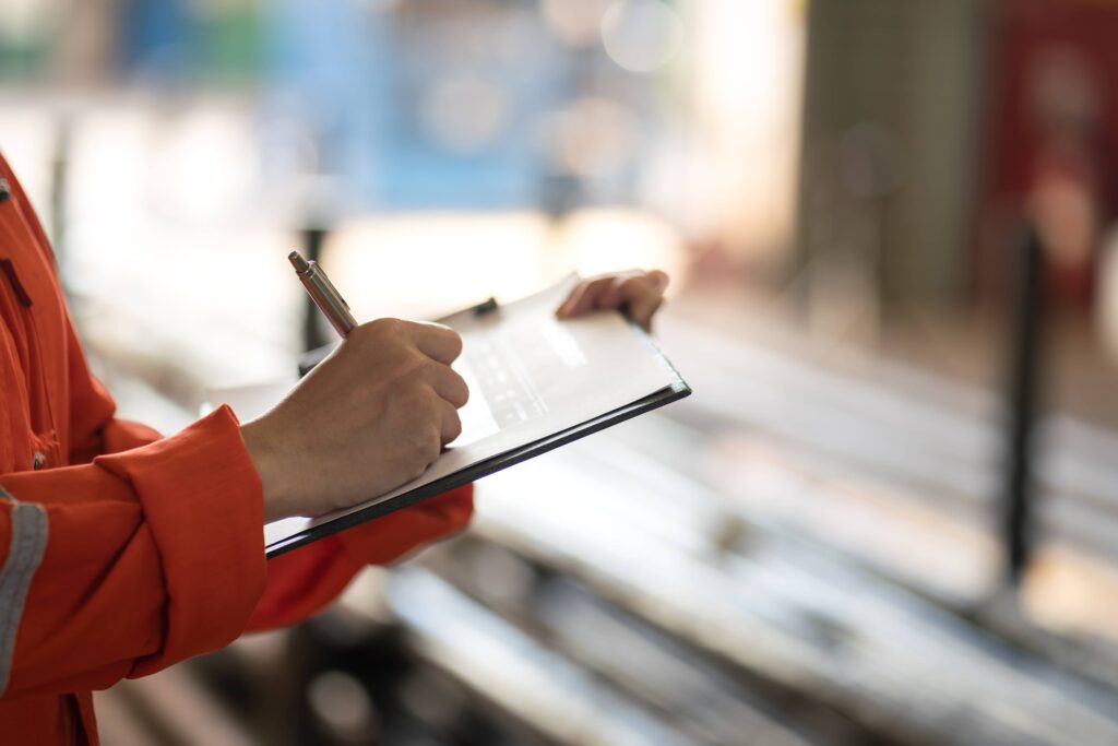 A person is writing down a few different risk mitigation strategies.
