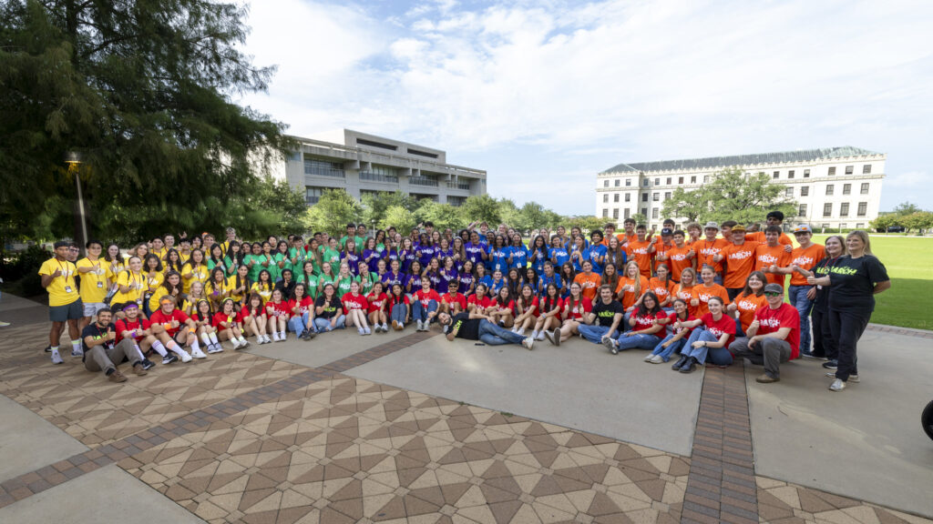 A large group of Camp ARCH students, instructors, and staff pose for a group photo.