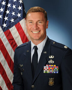 A man smiles for a military portrait.