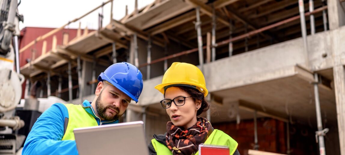 Construction Science Career Prospects going over notes together at a construction site