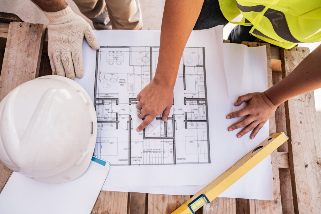 Close up of a construction workers analyzing blueprint on construction site