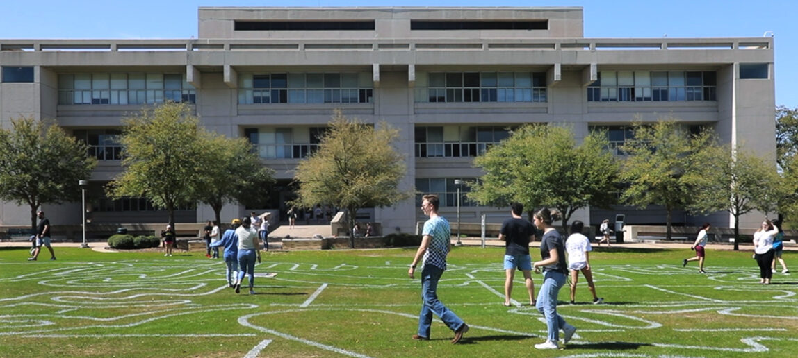 Students walk through a labyrinth patterns drawn on the Langford quad.